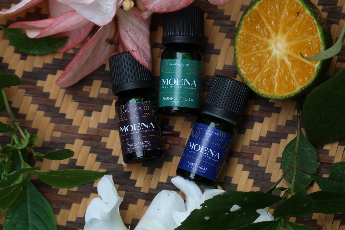 3 bottles of various Essential Oils on a woven surface