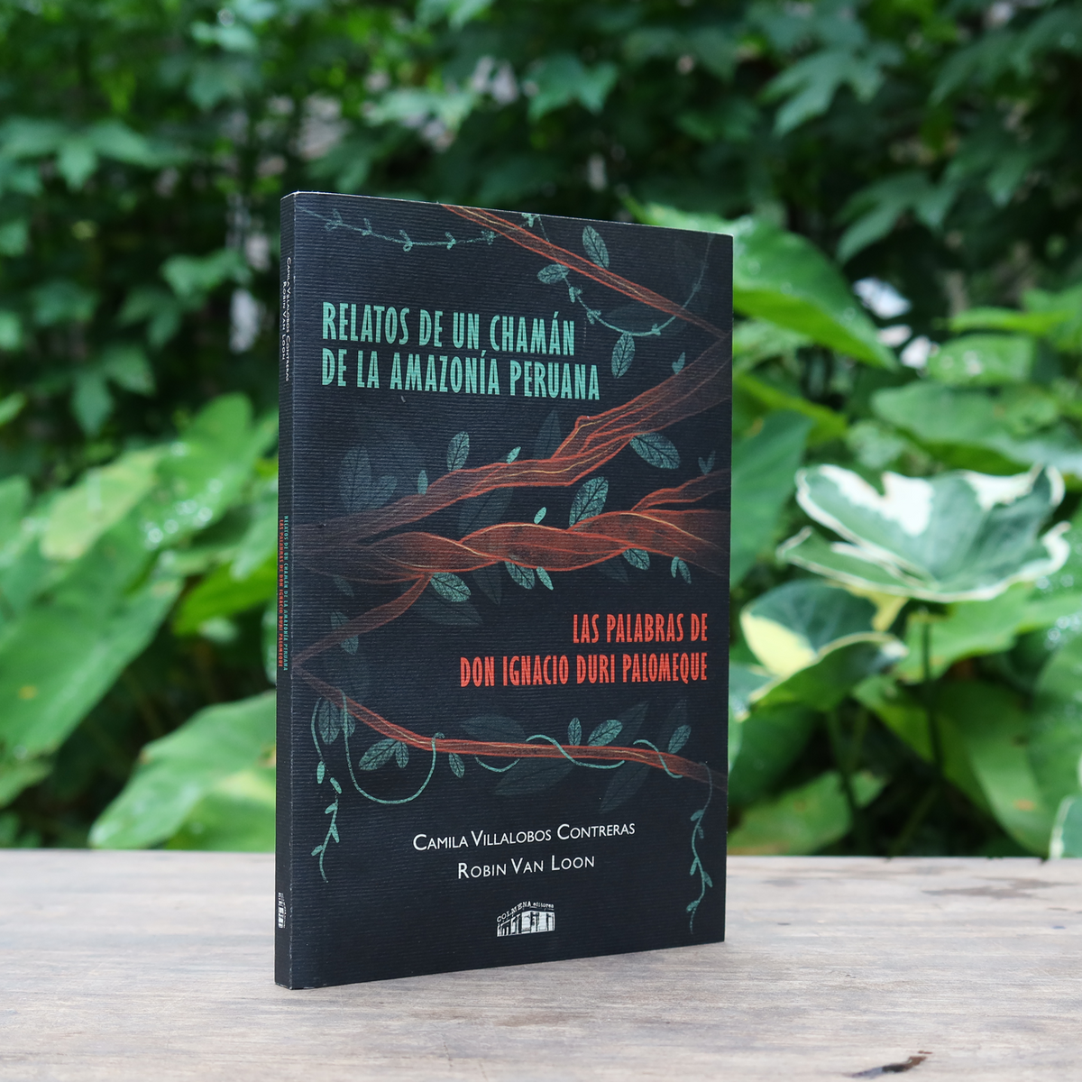 Las Palabras De Don Ignacio Duri Palomeque: Relatos de un Chamán de la Amazonía Peruana, Softcover Book sitting on a table with greenery in the background