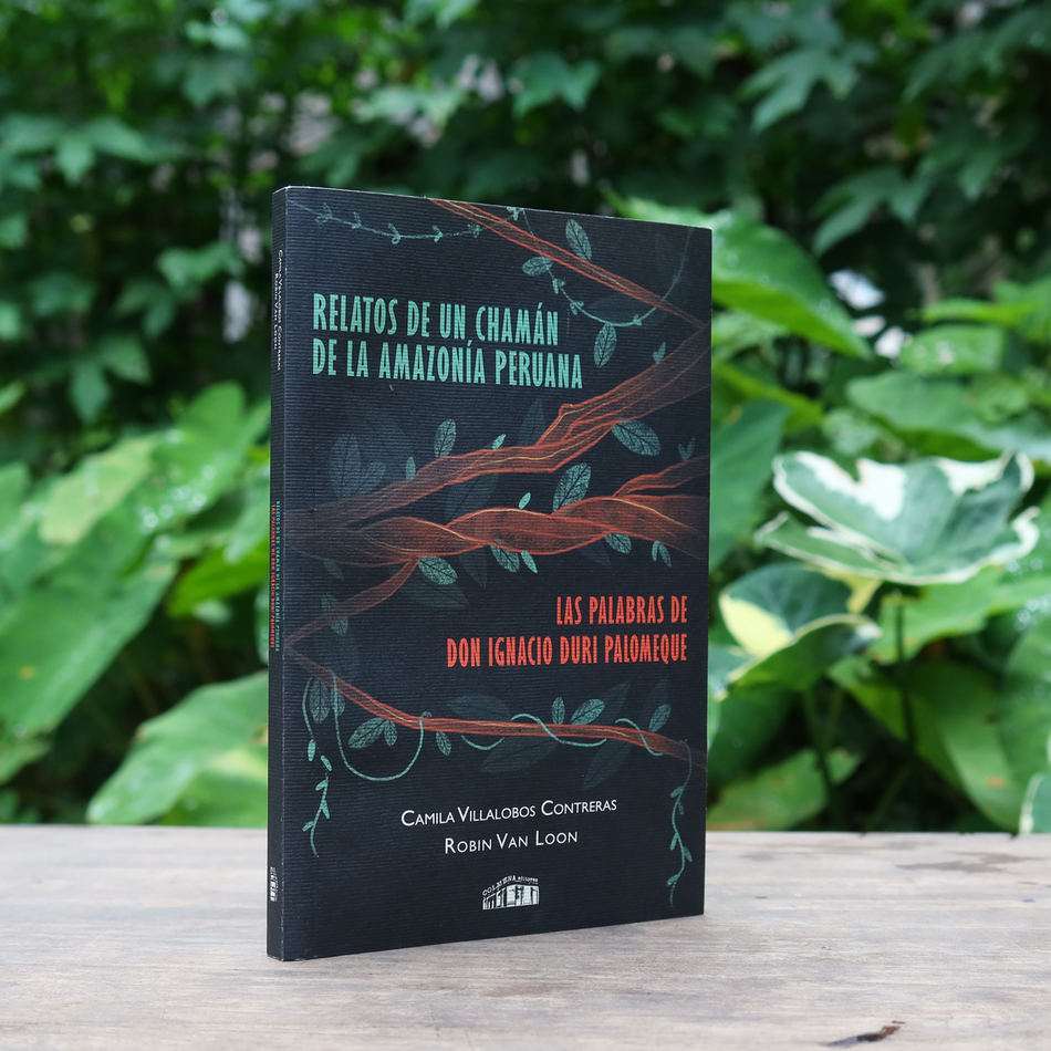 Las Palabras De Don Ignacio Duri Palomeque: Relatos de un Chamán de la Amazonía Peruana, Softcover Book sitting on a table with greenery in the background